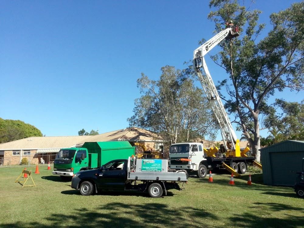 Tree Problem No Problem trucks and elevated work platform set up on a lawn